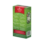 Side angle view of the Scentsicles 'White Winter Fir' scented ornament packaging. The green box is decorated with holiday-themed foliage and contains detailed instructions in English and French on how to assemble and use the ornament. A small image on the side shows the white star ornament hanging on a Christmas tree. The text highlights the product's ability to make trees smell fresh-cut, and the bottom section includes recycling and safety information.