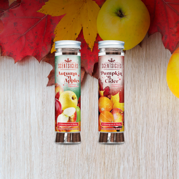 Scentsicles Autumn 'n' Apples and Pumpkin 'n' Cider scented ornaments on a wooden table with fall leaves and apples.