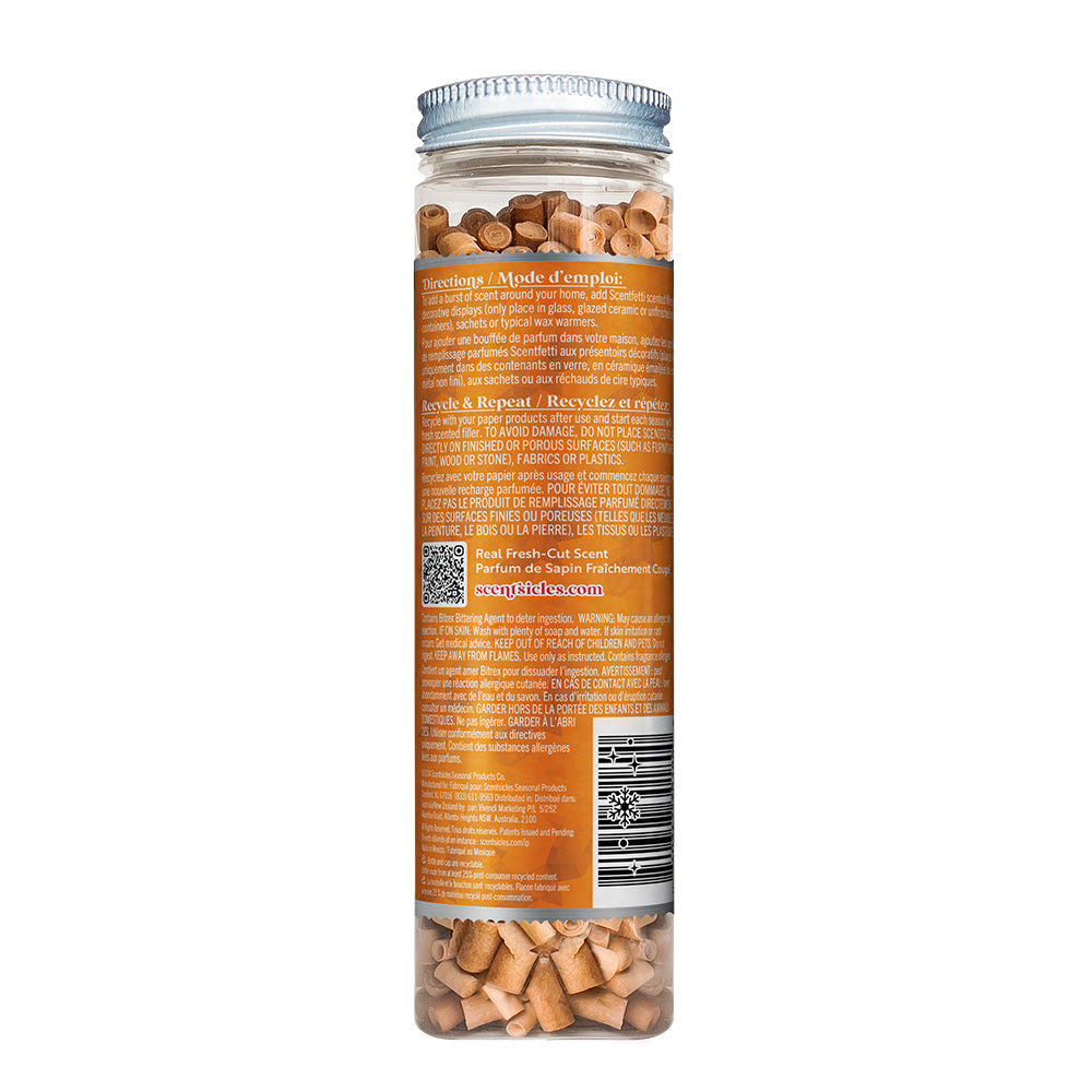 Back view of the Scentsicles 'Spiced Pine Cones' scented filler jar, showing the product instructions and ingredients on an orange label. The jar is filled with small scented wooden spirals, designed to release the fresh-cut scent of pine when placed around the home.