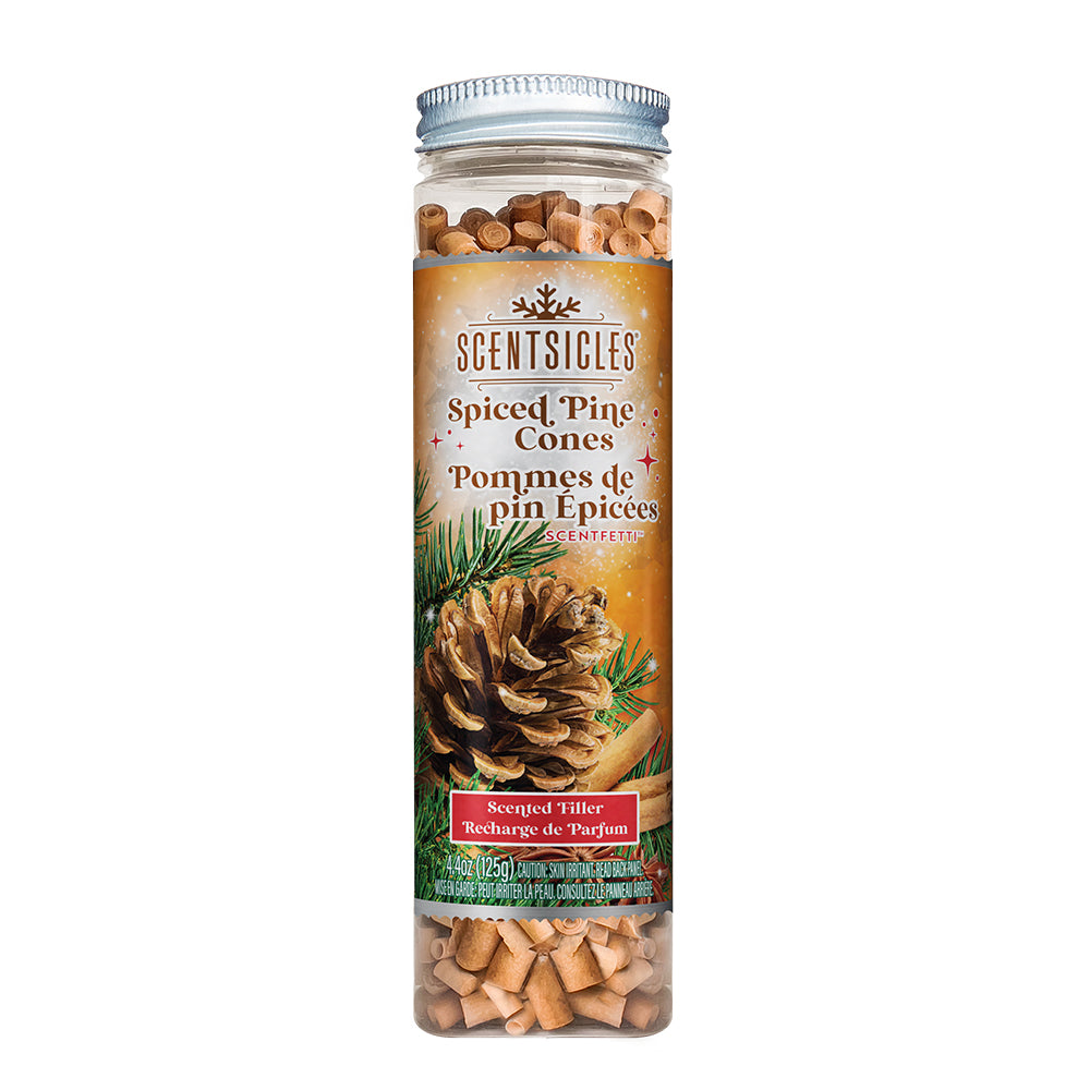 Front view of the Scentsicles 'Spiced Pine Cones' scented filler jar, displaying the product label with an image of a pine cone and cinnamon sticks against a warm, festive background. The jar is filled with small scented wooden spirals, intended to infuse spaces with the comforting aroma of spiced pine cones.