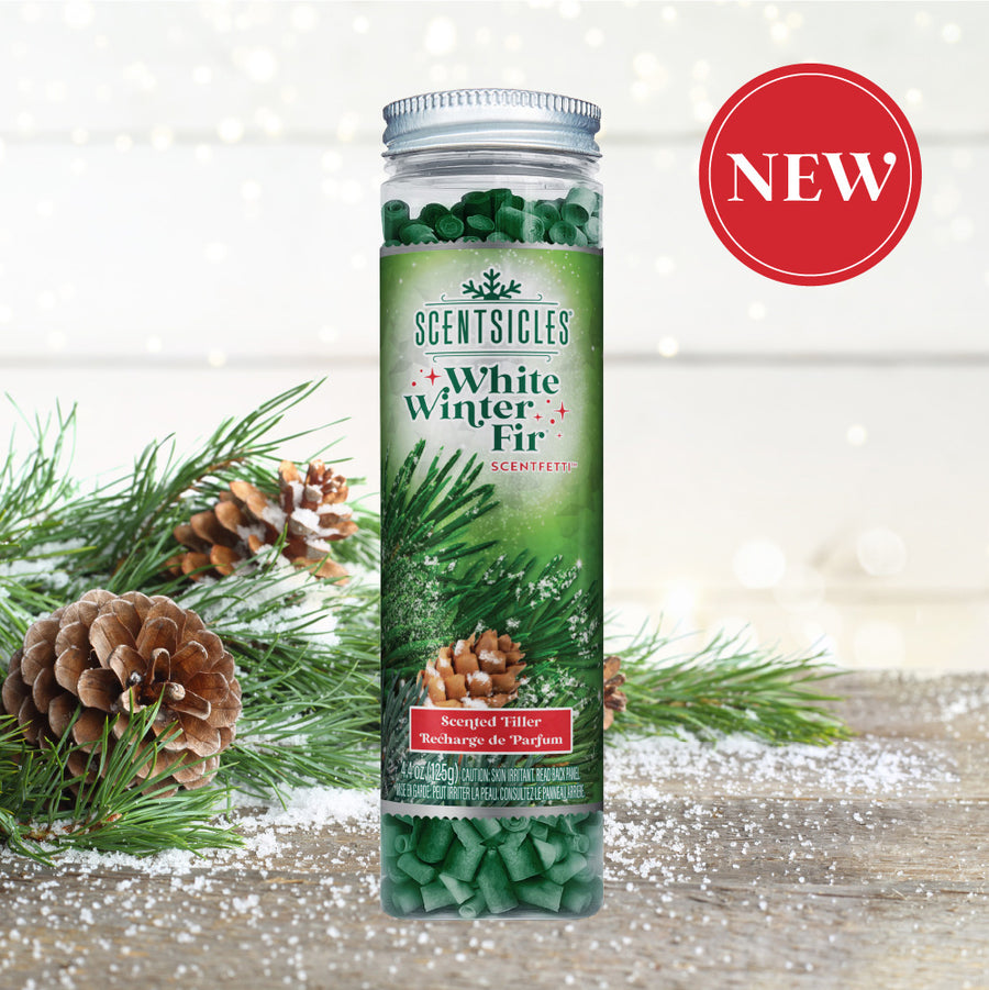 Scentsicles 'White Winter Fir' scented filler displayed against a snowy, festive backdrop with pinecones and evergreen branches, emphasizing the product's newness with a red 'NEW' badge in the top right corner.